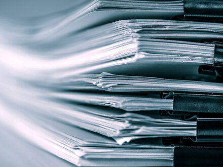 stack of report papers on a desk