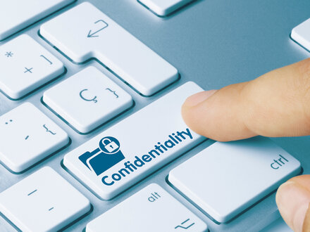 person pressing confidentiality button on computer keyboard