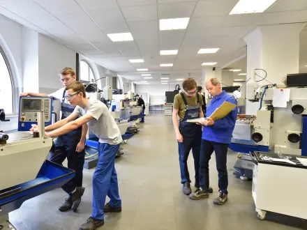 Group of young people in technical vocational training with teacher 