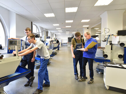 Group of young people in technical vocational training with teacher