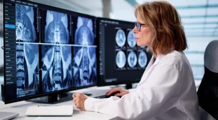 A female Radiology reviewing scans via teleradiology software