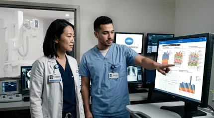 A rad tech and radiologist reviewing data charts from AeroRemote Insights