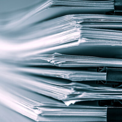 stack of report papers on a desk