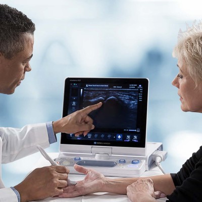 Doctor reviewing ultrasound with patient on an HS1 device