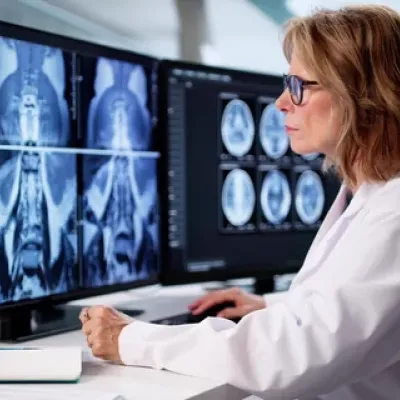 A female Radiology reviewing scans via teleradiology software
