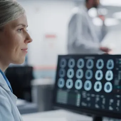 A Radiologist reading scans on a computer monitor