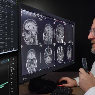 A Radiologist reading scans on a computer monitor