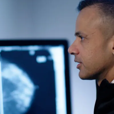 A Radiologist reading scans on a computer monitor