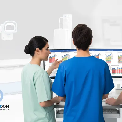 3 technicians reviewing data on a computer in an X-ray room