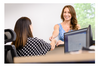 A patient checks in at the reception desk for her healthcare appointment